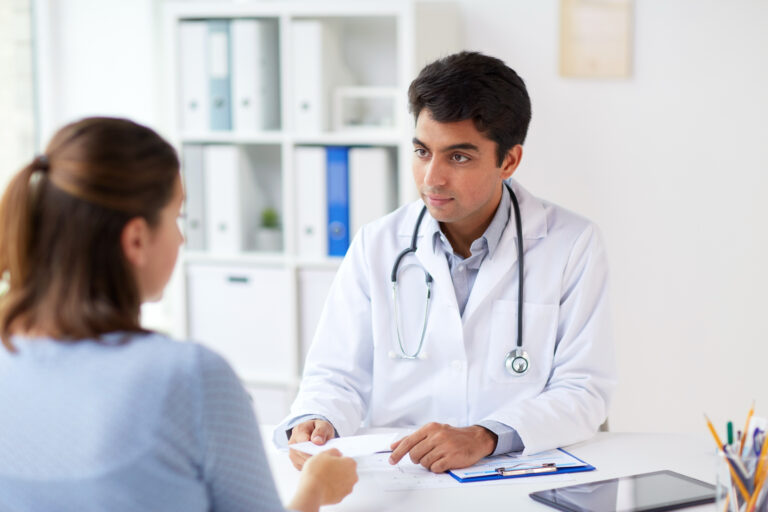 Woman talking to doctor